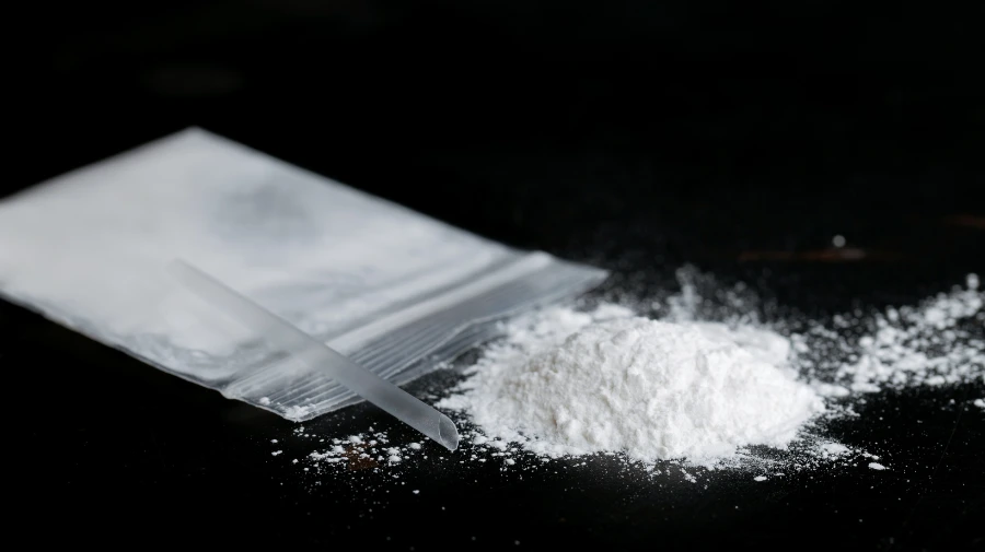 A pile of ketamine powder with a straw shows the signs of ketamine addiction