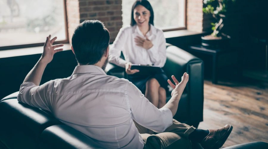Doctor and patient sitting, displaying the Benefits From Narrative Exposure Therapy