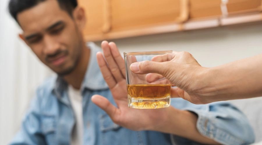 Man passing up on glass of whiskey show that_It is Important Not to Drink with Bipolar