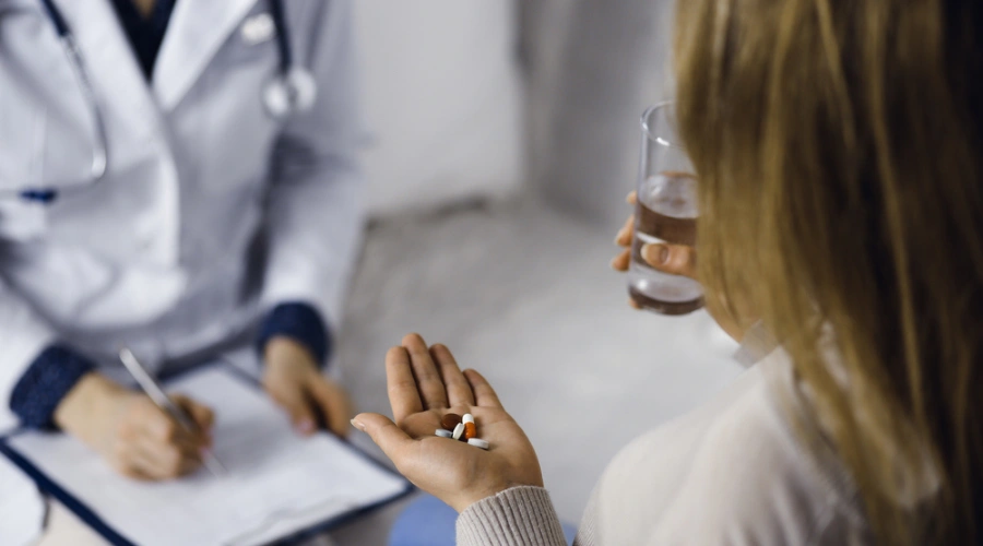 Patient with pills in hand taking the Naloxone Challenge Test for Recreational Drugs
