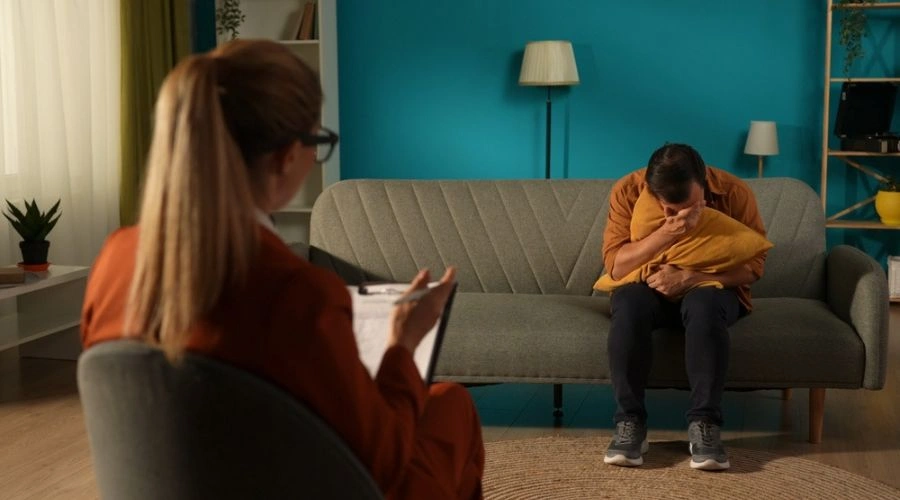 Man in therapy with his face next to a pillow Seeking Help for Bipolar Disorder