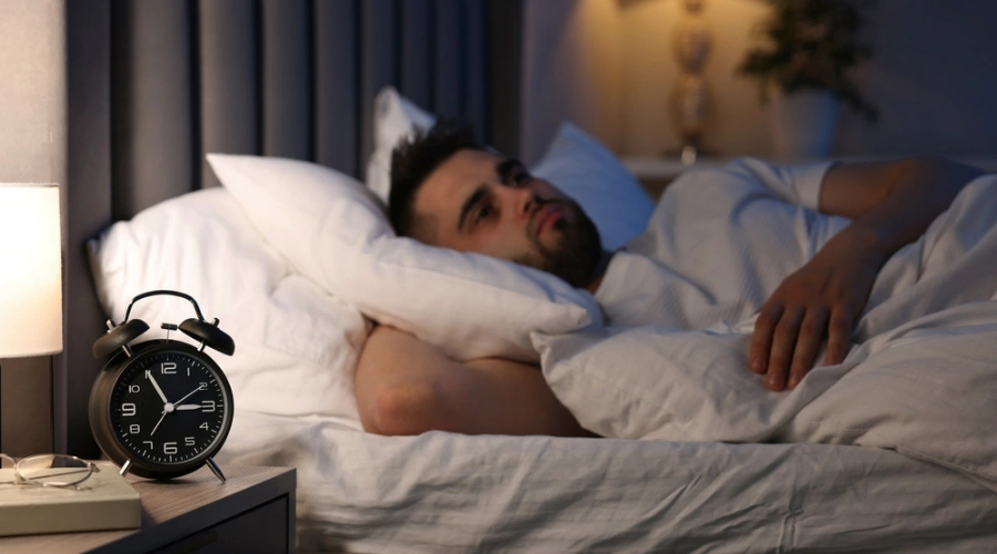 Man in bed unable to fall asleep. displaying the Ultram Withdrawal Symptoms - Insomnia