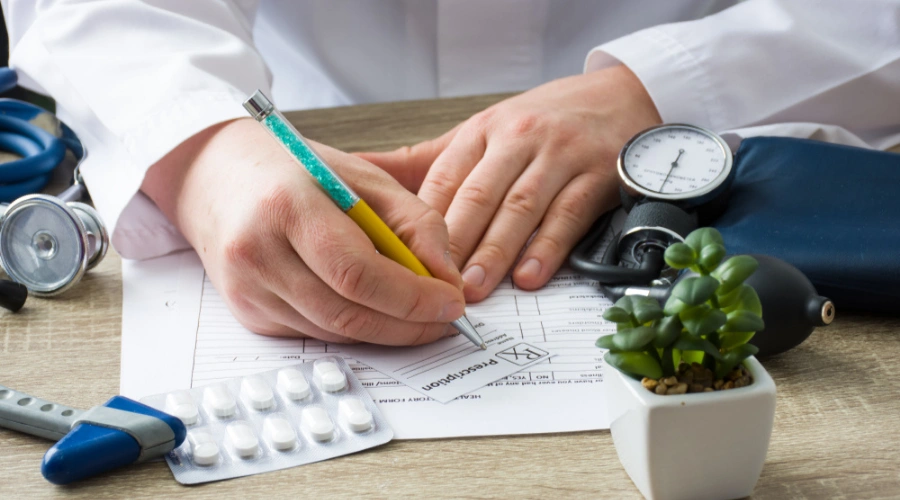 Doctor writing a prescription displaying Uses for Prescription Medication - Low-dose Naltrexone