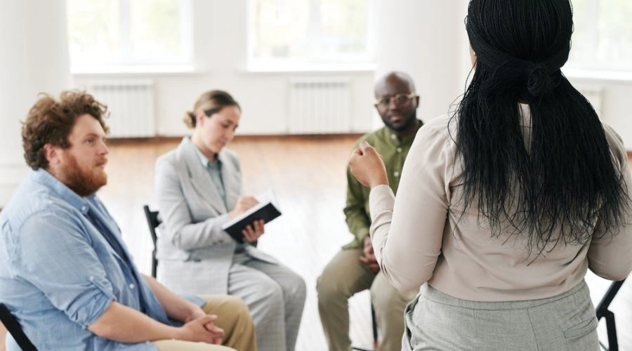 Four people in a group display What Is Narrative Exposure Therapy