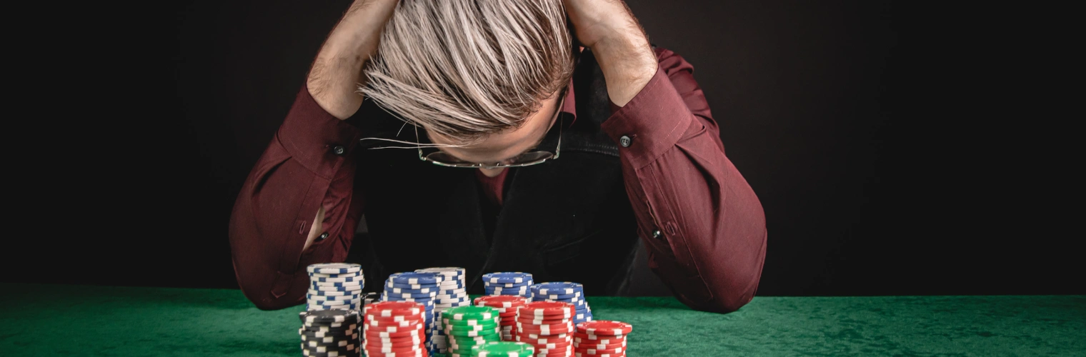 Devastated Gambler Man Losing a Lot of Money Playing Poker in Casino - Can You Write Off Gambling Losses