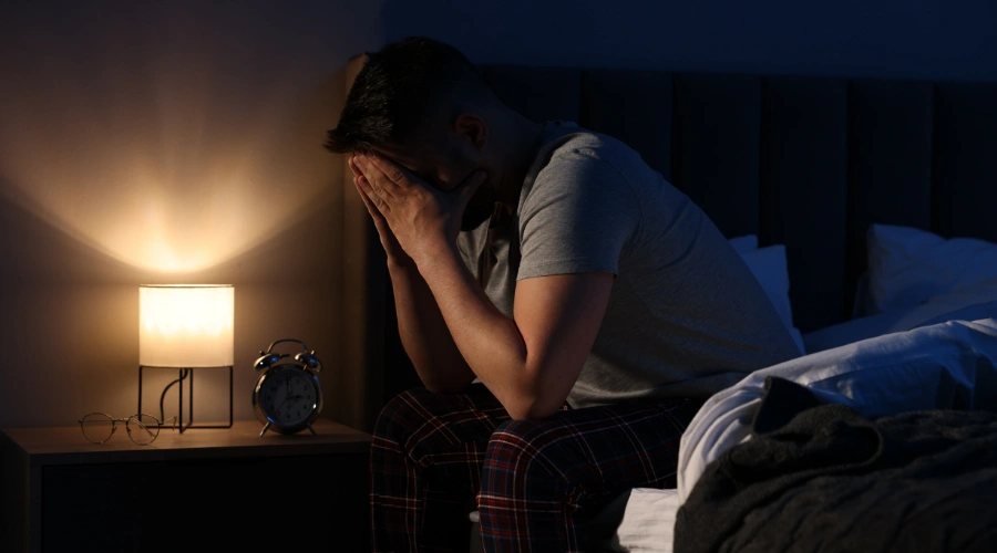 Image of a frustrated man suffering from sleep disorder caused by gambling withdrawal