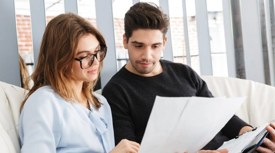 Man and woman reviewing a written apology together