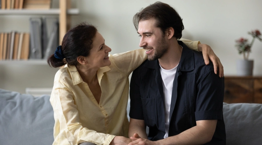 Mother and adult son smiling during heartfelt Step 9 amends conversation