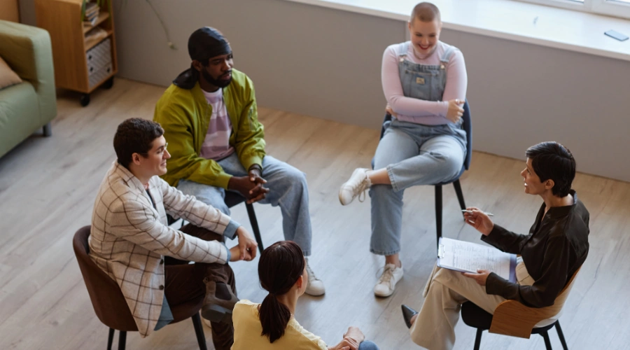 Image of recovery group members discussing early sobriety challenges and sharing coping strategies