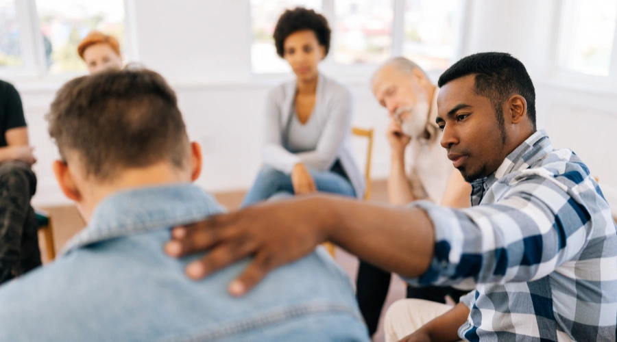 People in a recovery group therapy session sharing experiences and supporting each other