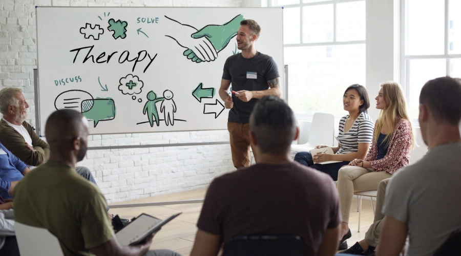 Recovery group members practicing role-playing and life skills during a therapy session