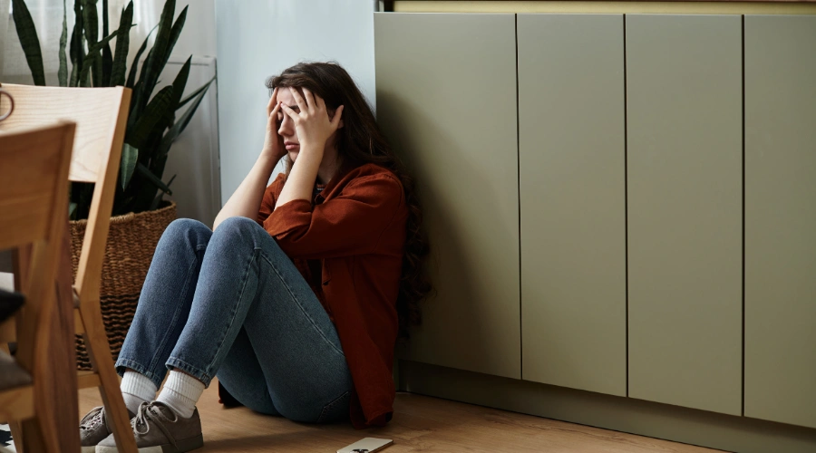 Image of a person reflecting quietly at home and processing emotions related to generational trauma