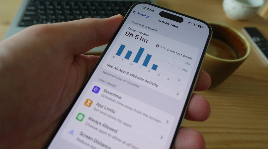 Image of a person viewing screen time data on their smartphone
