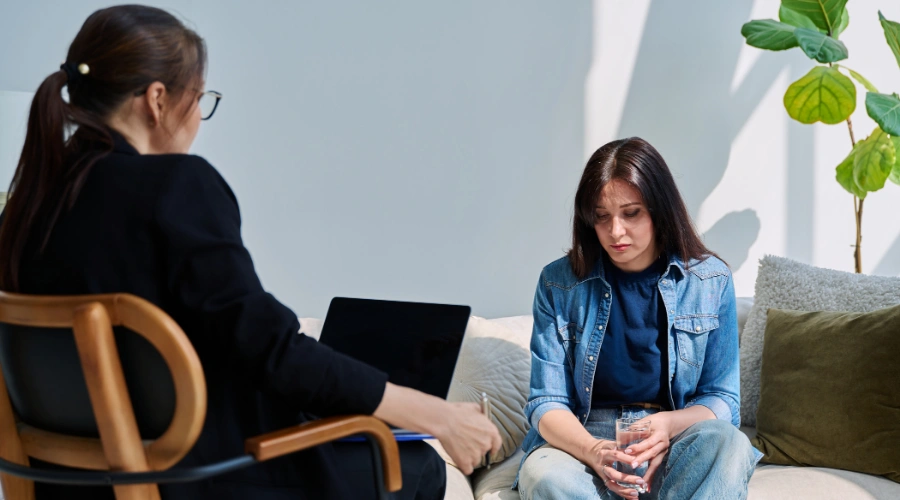 Image of a therapist guiding a client through a trauma-focused therapy session in a calm, supportive setting