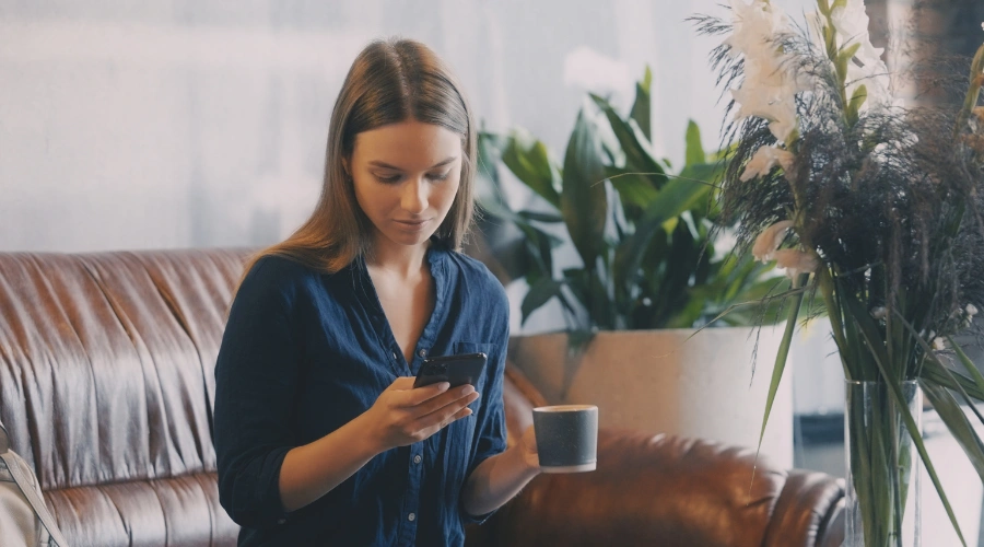 Image of a young woman scrolling through TikTok on her phone