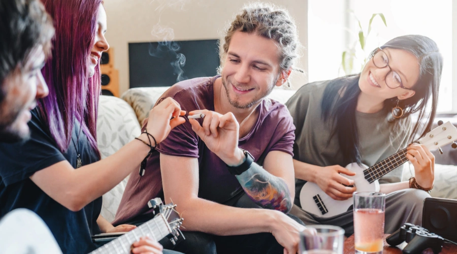 Image of friends laughing together while smoking weed recreationally