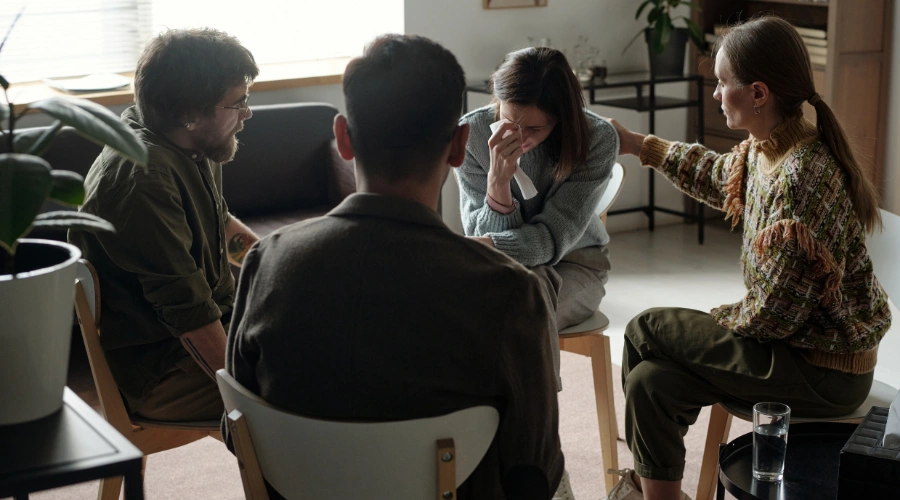 Image of people participating in group counseling to build a support system during addiction treatment