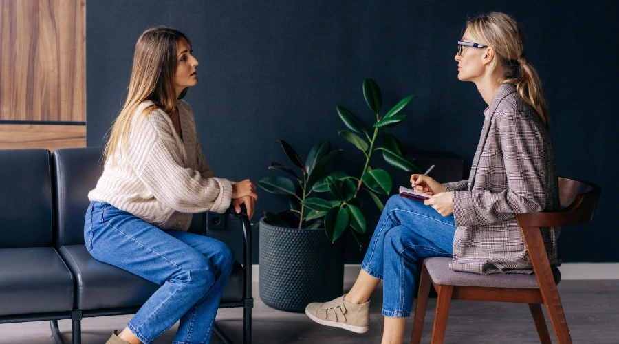 Image of therapist supporting client in reframing negative thoughts to overcome procrastination caused by childhood trauma