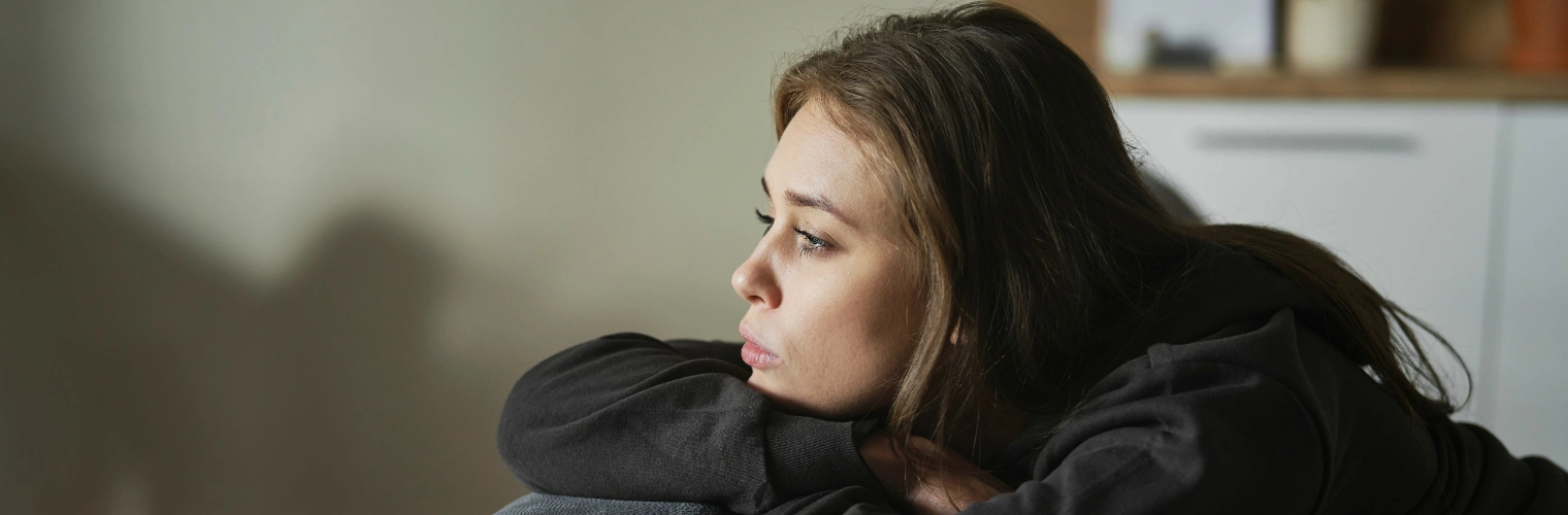 Image of a woman in despair staring into space - Is Not Remembering Your Childhood A Sign of Trauma - Icarus Behavioral Health