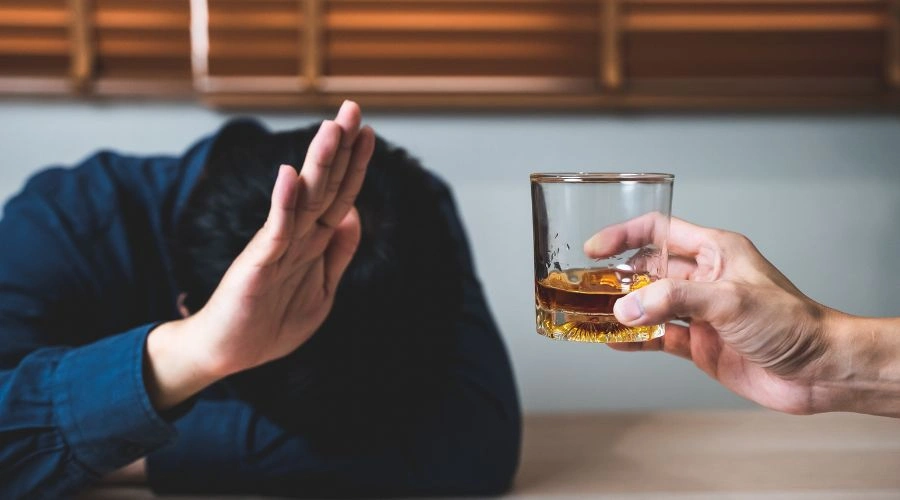 Image of a man refusing a drink, representing dry drunk syndrome and the struggle to maintain sobriety