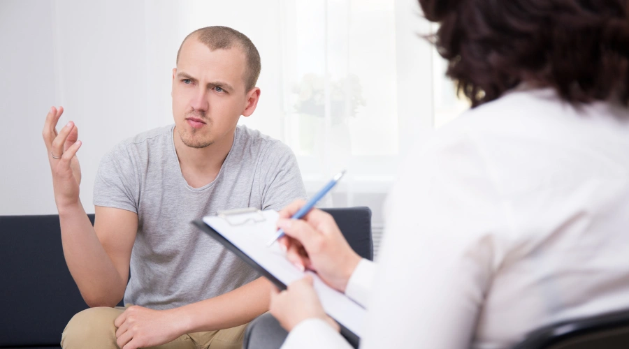 Image of a man on probation in a rehab program talking with his counselor at a private treatment center in Nevada