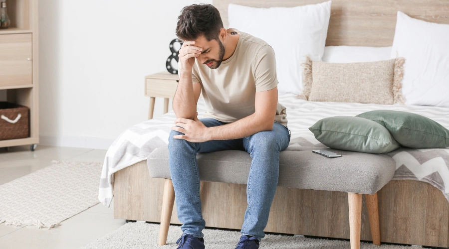 Image of a man in deep despair, displaying the internal and external triggers that can worsen anxiety